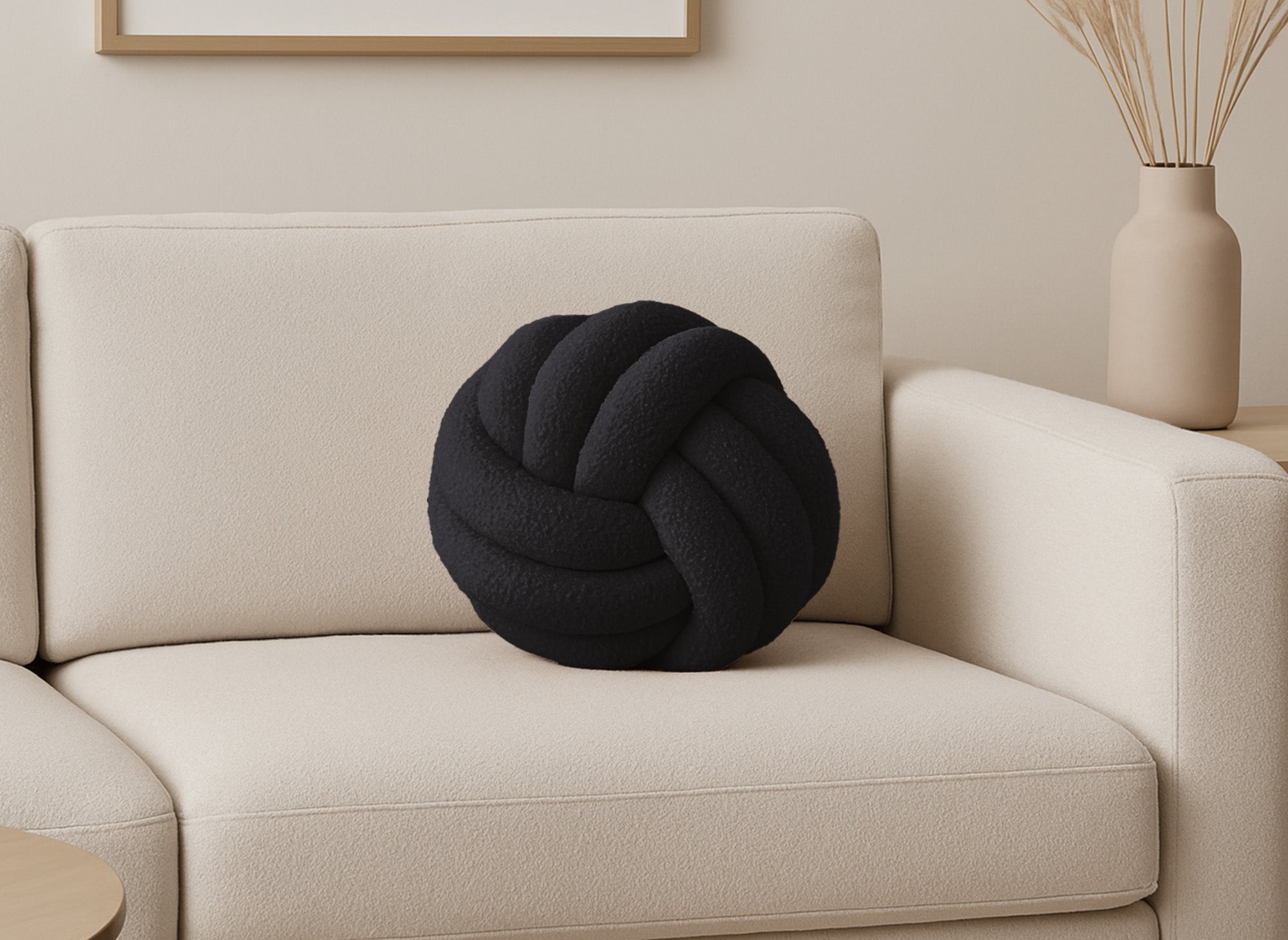 Coussin rond décoratif boule de nœud en effet peau de mouton noir NODUS